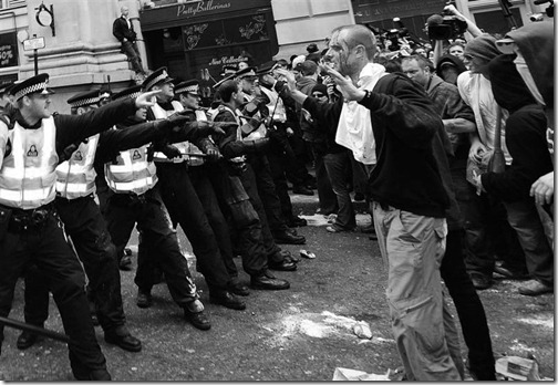 riot_police_confront_protesters_near_the_bank_of_e_8076680694
