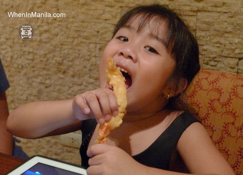 girl resorts world manila eating tempura