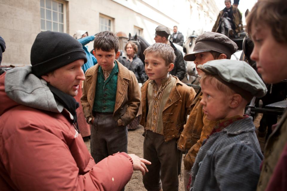 Director Tom Hooper with some of the younger stars on the set of Les Misérables!