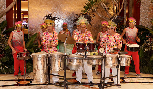 Drummers playing fun Brazilian beats to welcome guests at the lobby of Solaire