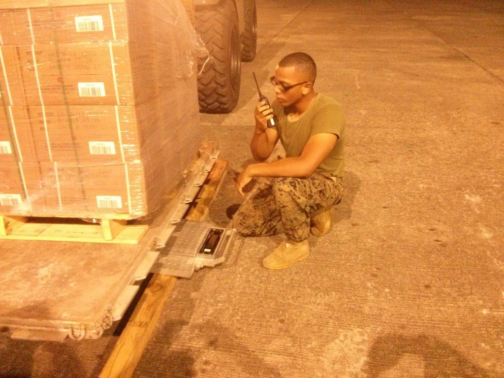 U.S. Marine preparing a pallet of relief supplies