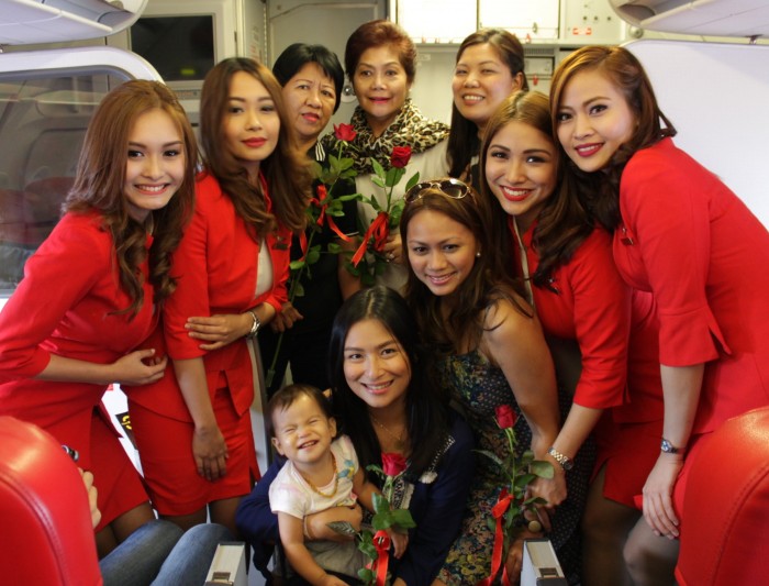 5th from left back row) AirAsia Philippines CEO Joy Caneba and cabin crew with mothers on board the airline’s first Manila-Hong Kong flight last Friday. AirAsia gave flowers to all mothers on board flight Z21201 to celebrate Mother’s day