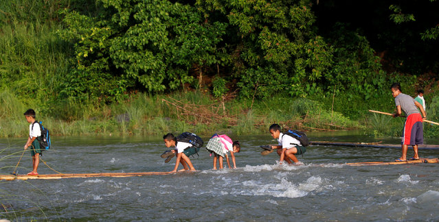 Children ride raft to school (1)