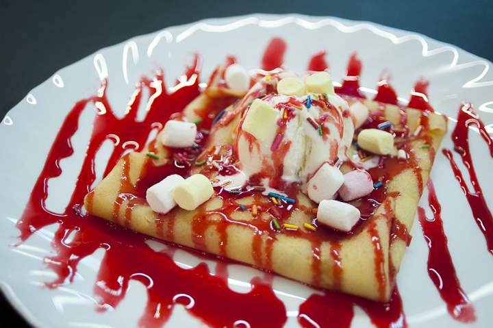 Mango crepe with strawberry syrup