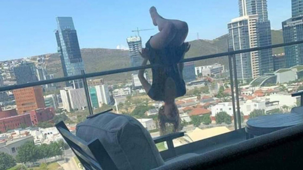 woman extreme yoga balcony fall