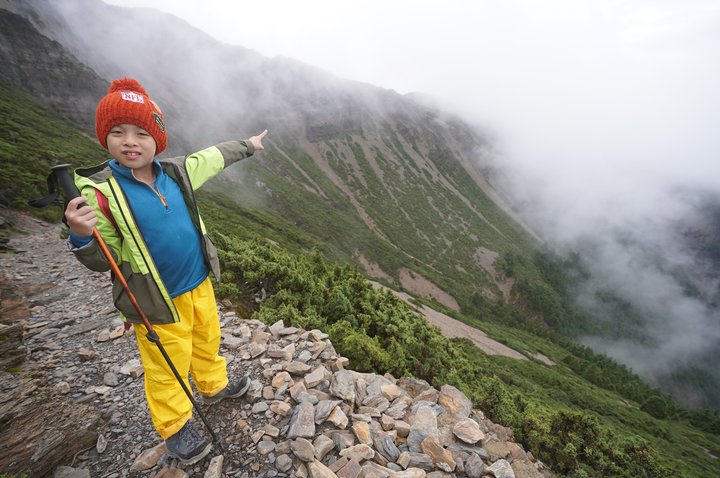 boy hikes up mountain 2