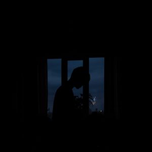silhouette of person standing near window 3334070