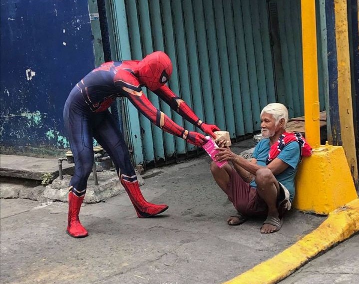 spiderman distributes food to homeless