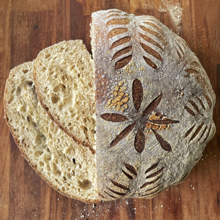 Rise Artisanal classic sourdough boule sliced with fancy scoring scaled e1665569723641