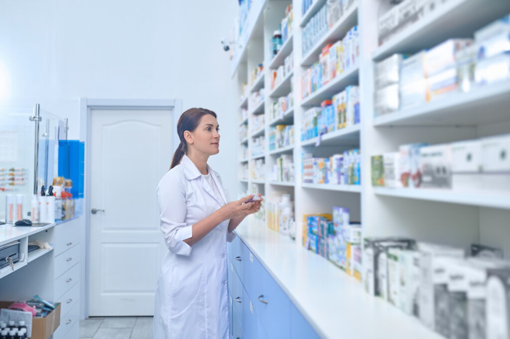 female pharmacist working drugstore