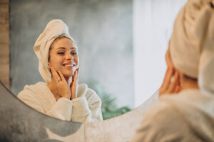 Non-Invasive Methods to Try at Home to Maintain Young-Looking Skin 1 woman home applying cream mask