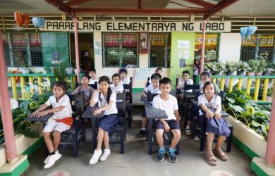 Labo Elementary School students with recycled chairs from traded in Samsonite luggage pieces 1