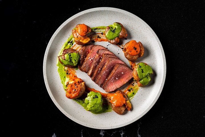 rsz presa iberico con patatas y mojos grilled pork iberico steak fried marble potatoes green and red mojos sauces