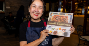 Adoboqueen” Chef Nancy Reyes-Lumen shows a copy of the “U.S. Poultry Adobo Collection,” published with the support of the U.S. Department of Agriculture’s Foreign Agricultural Service in Manila, the USA Poultry and Egg Export Council, and the United Soybean Board