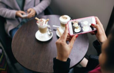 Taking photos of food with phone at a cafe