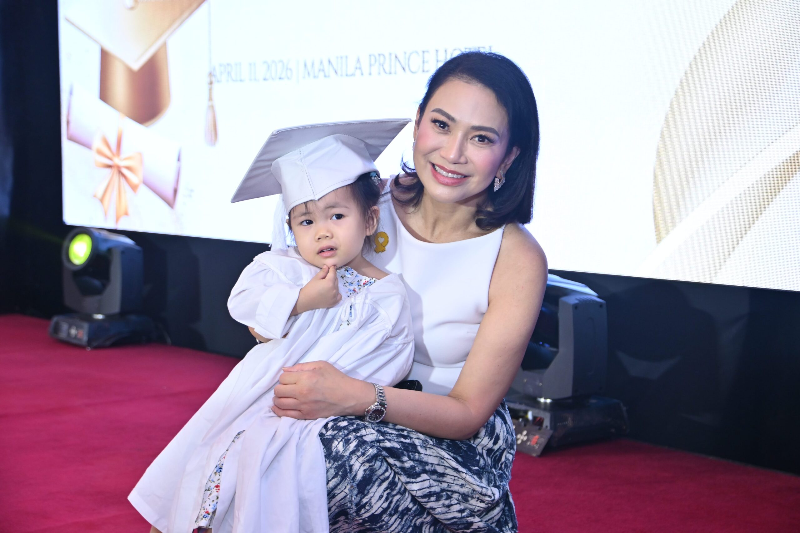 Ms. Sheila Romero with one of the young graduates.