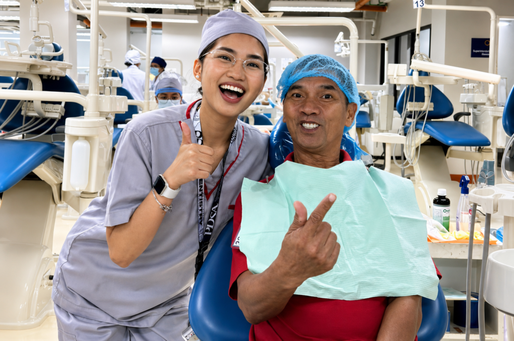 The Price of a Smile: How Student Dentists and Rural Clinics are Bridging the Philippines' Dental Care Gap 1 UE Dentistry student Lucia Aguinaldo and patient Kuya Carlos