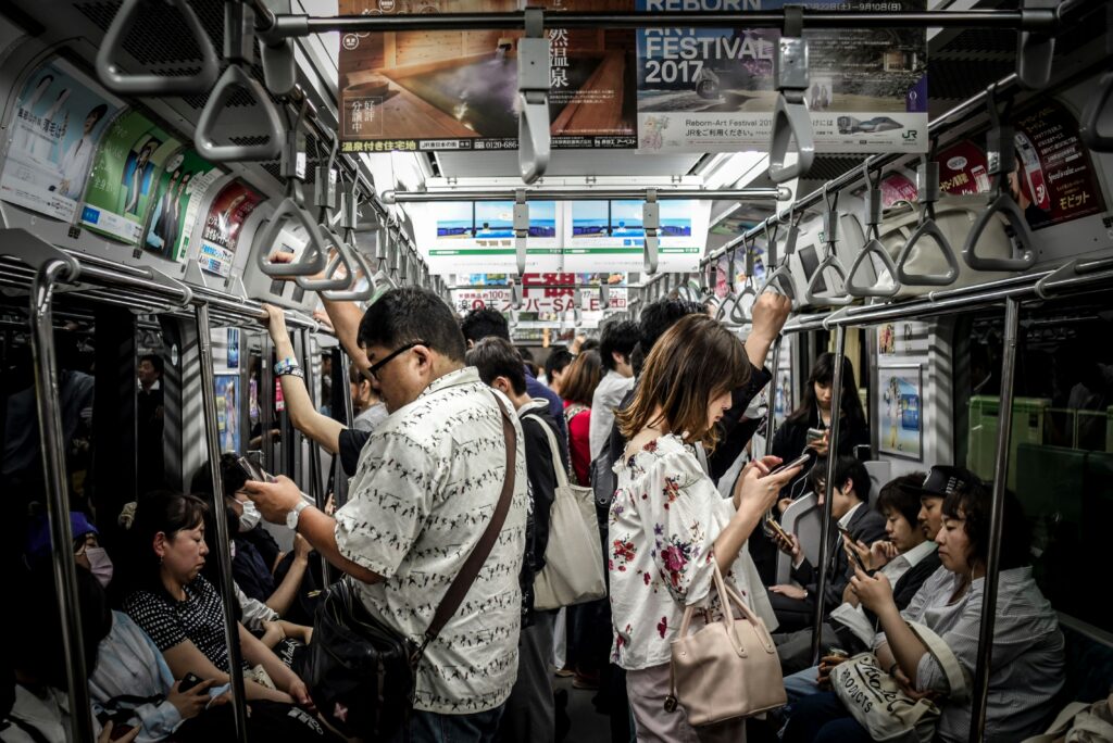 Filipinos Quickest to Ditch Tech Brands After a Data Breach or Scam, Study Shows 3 People using phone in the train