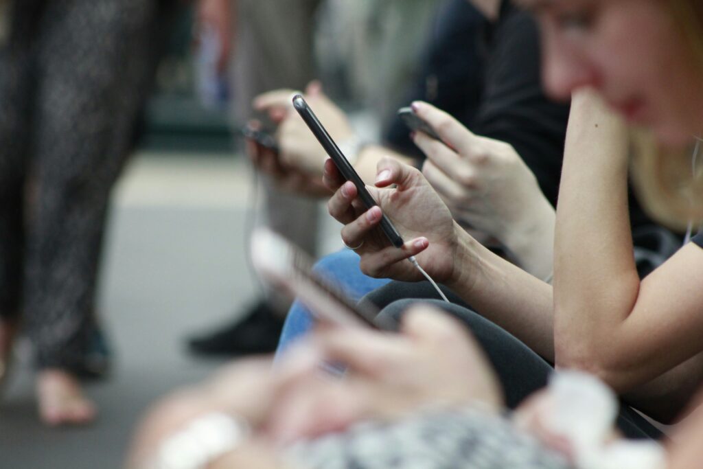 Filipinos Quickest to Ditch Tech Brands After a Data Breach or Scam, Study Shows 4 People using phone